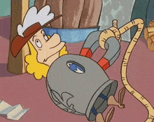 a cartoon character with a cowboy hat is laying on the floor with a magnet around his neck .