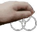 a close up of a person 's hand holding a pair of wedding rings .