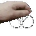 a close up of a person 's hand holding a pair of wedding rings .