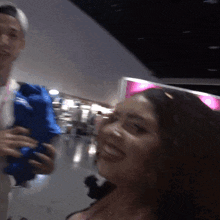 a man holds a blue bag over a woman 's face