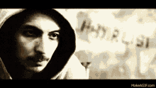 a man with a beard and mustache is wearing a hoodie .