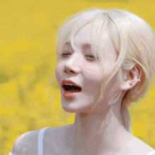 a woman stands in a field of yellow flowers