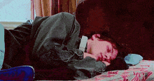 a person is laying on a bed with their head on their stomach