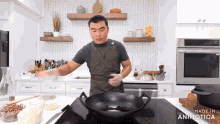a man cooking in a kitchen with the words made in animatica on the bottom of the screen