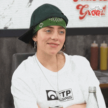 a woman wearing a bandana and a tp gris shirt