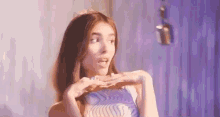 a close up of a woman making a funny face with her hands .