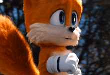 a close up of a stuffed animal that looks like a squirrel with blue eyes