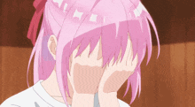 a girl with pink hair is covering her face with her hands in a cartoon .