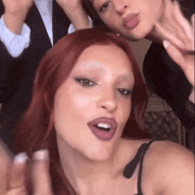 two women with red hair are taking a selfie together .