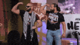 two men wearing shirts that say athletes rule are flexing their muscles