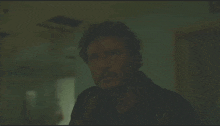 a man holding a gun in front of a window with a light coming out of it
