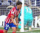 a soccer player with the number 24 on his shorts is celebrating