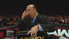 a man in a suit is sitting in front of a sign that says evolution
