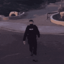 a man in a police uniform walking down a street