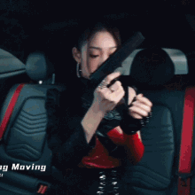 a woman is holding a gun out of a car window with the words moving moving below her