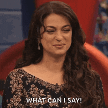 a woman says " what can i say " while sitting on a red chair