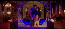 a man and woman are standing next to each other in a room with purple lights .