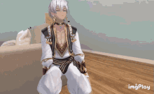 a gif of a man sitting on a couch with the words imgplay behind him