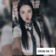 a blurred image of a woman with the letters crom ra 11 on the bottom
