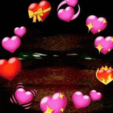a circle of pink hearts on a black background .