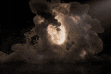 a large explosion with smoke coming out of it in a dark room