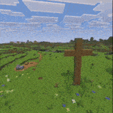 a wooden cross in the middle of a field