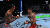 two men are fighting in a cage with a vebetter.com banner in the background