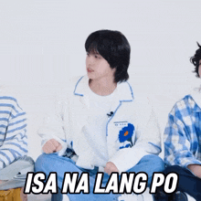 a man in a white jacket is sitting on the floor with his hands in the air and the words " isa na lang po " above him