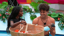 a man and woman are holding a baby in a wicker basket
