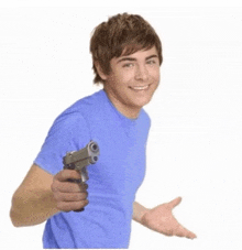 a man in a blue shirt is pointing a gun