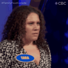 a woman with a name tag that says tara on it