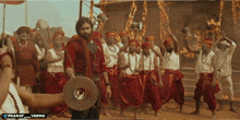 a man holding a megaphone in front of a group of people with the words pranay varma on the bottom