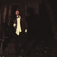 a man in a tuxedo and white gloves is dancing