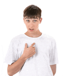a young man in a white t-shirt points to his chest