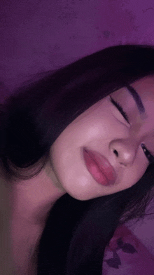 a close up of a girl 's face with her eyes closed