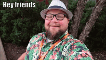 a man wearing a hat and glasses is smiling and says hey friends
