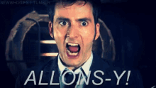 a man in a suit and tie is screaming with the words allons-y written below him
