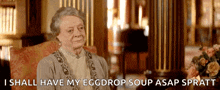 an elderly woman is sitting in a chair and says i shall have my eggdrop soup asap sprott