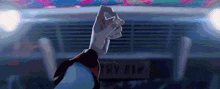 a person 's fist is raised in the air in front of a car with a license plate that says rv 412