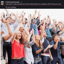 a crowd of people with their arms in the air and a caption that says so i am a femboy