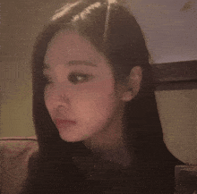 a close up of a woman 's face with a blurry background