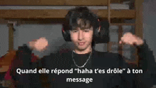 a man wearing headphones is making a funny face with the words quand elle répond