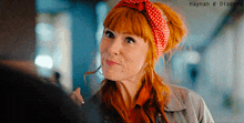 a woman with red hair wearing a red and white polka dot headband with haynah @ discord written below her