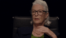 an older woman wearing glasses with the words which are the two least offensive in red