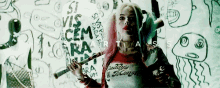 a woman in a daddy 's monster shirt holds a knife