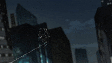 a blurry picture of a city at night with tall buildings