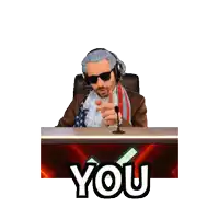 a man sitting at a desk with a microphone and the words youngest