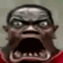 a close up of a person 's face with a very angry look on it .