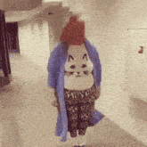 a woman wearing a cat sweater and a blue robe
