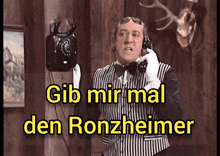 a man talking on a phone with the words gib mir mal den ronzheimer written below him